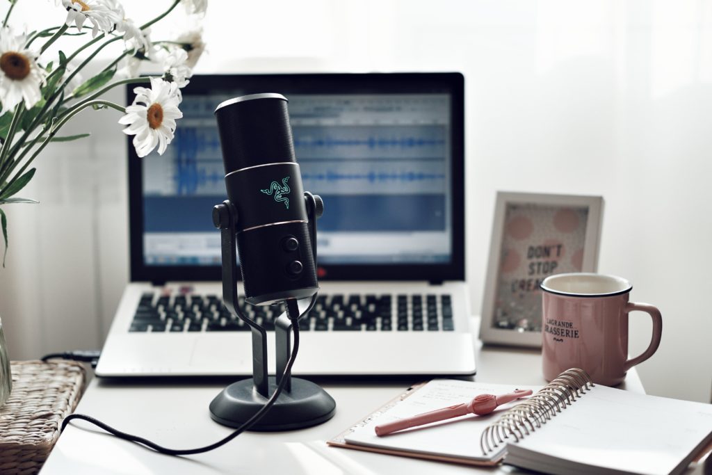 microphone on desk with mug and laptop